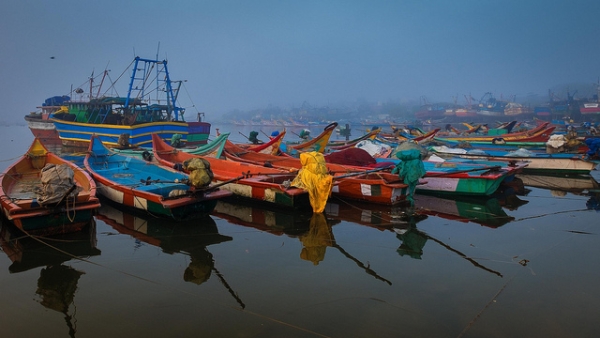 A row of brightly painted boats are moored at Kasimedu harbor in Chennai, India on January 3, 2015. (Ramesh SA/Flickr)