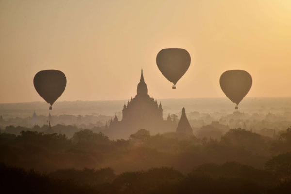 Hot air balloons fly over ancient temples in Bagan, Myanmar, at sunrise on November 25, 2014. (Phyo Hein Kyaw/AFP/Getty Images)