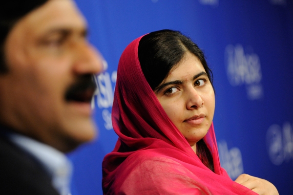 Malala Yousafzai listens as her father, Ziauddin Yousafzai, addresses attendees at Asia Society on Saturday, September 26. (Elena Olivo/Asia Society)