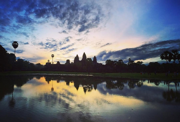 The sky is streaked in shades of gold and blue during sunset over Angkor Wat, Cambodia on October 8, 2015. (Philip Lai/Flickr)