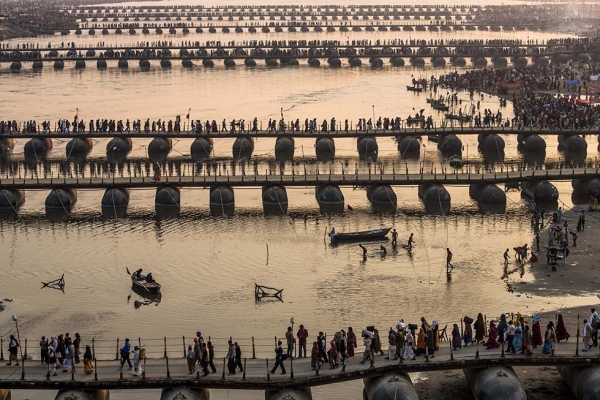 Hindu pilgrims make their way over pontoon bridges near Sangam, the confluence of the holy rivers Ganges, Yamuna and the mythical Saraswati, during the Maha Kumbh Mela on February 9, 2013 in Allahabad, India. (Daniel Berehulak/Getty Images)