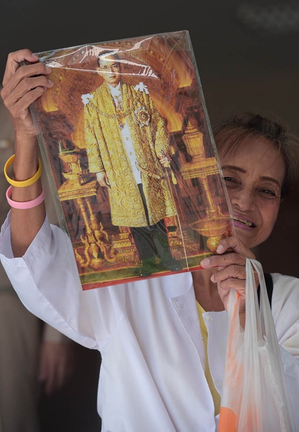 A Thai well-wisher holds a portrait of Thai King Bhumibol at Siriraj Hospital in Bangkok on June 1, 2015. (Pornchai Kittiwongsakul/AFP/Getty Images)