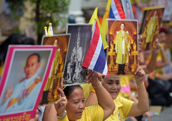 Thai well-wishers hold portraits of Thai King Bhumibol Adulyadej while waiting in front of Siriraj hospital in Bangkok on May 5, 2015. (Pornchai Kittiwongsakul/AFP/Getty Images)