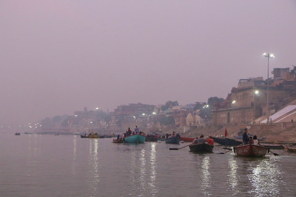 A row of boats wait by the banks of the Ganges river in Varanasi, India on November 23, 2015. (Juan Antonio F. Segal/Flickr)