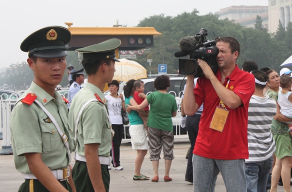 A foreign reporter films authorities in Beijing. (Noel Hidalgo/Flickr)