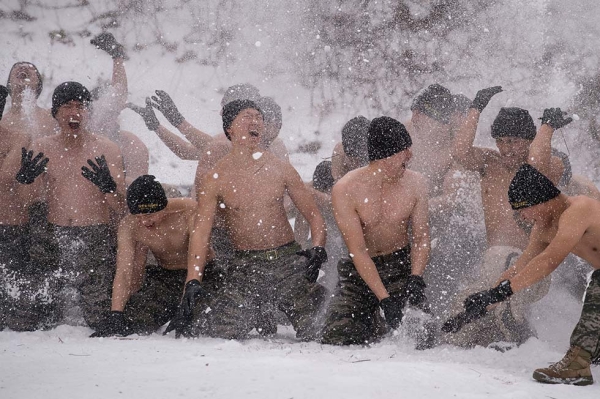 South Korean and U.S. soldiers hurl snow into the air as they pose for photographers during a joint annual winter exercise in Pyeongchang, some 115 miles east of Seoul, on January 28, 2016. (Ed Jones/AFP/Getty)