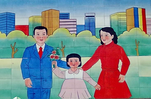 A mural in a village near Beijing stresses adherence to China's birth limits. (Eric Fish/Asia Society)