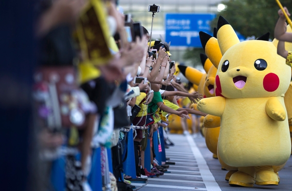 Performers dressed as Pikachu, a character from Pokémon, march during the Pikachu Outbreak event hosted by The Pokémon Co. on August 7, 2016 in Yokohama, Japan. (Tomohiro Ohsumi/Getty Images)
