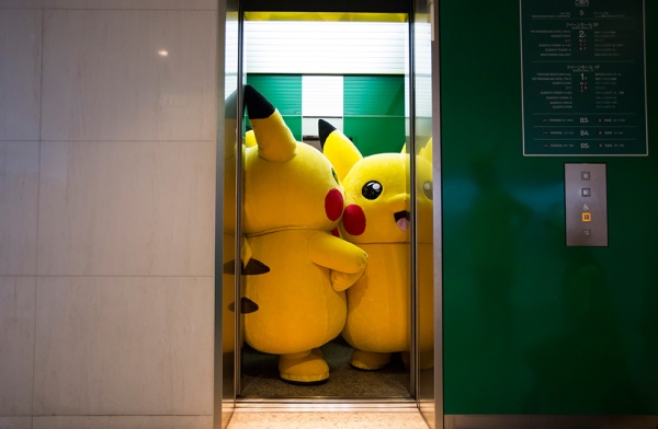 Performers dressed as Pikachu ride on an elevator during the Pikachu Outbreak event. (Tomohiro Ohsumi/Getty Images)

