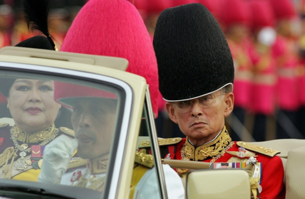 Thai King Bhumibol Adulyadej (R), Queen Sirikit and Crown Princess Maha Vajiralongkorn (F) return after reviewing the honor guard as a part of the celebration to commemorate his 78th birthday at the Royal Plaza in Bangkok, December 2, 2005. (Saeed Khan/Getty Images)