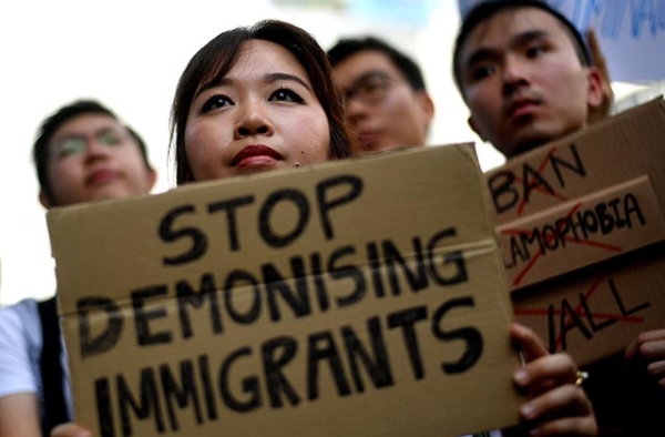 Malaysian activists hold placards during a protest against U.S. President Donald Trump's immigration order outside the U.S. Embassy in Kuala Lumpur on February 3, 2017. (Manan Vatsyayana/AFP/Getty Images)