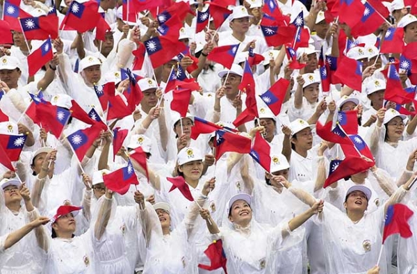 Taiwanese people wave the national flag during a gathering on the square by the Presidential Office in Taipei to celebrate the island's National Day in 2005. (Patrick Lin/AFP/Getty) 