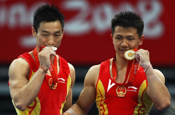 Chinese gymnasts pose with their medals at the 2008 Olympic Games in Beijing. (Jonathan Ferrey/Getty)