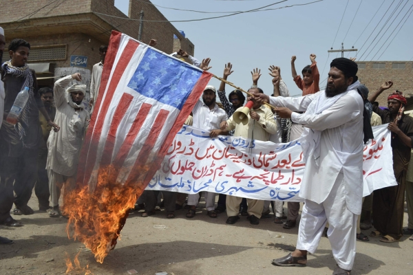 An activist of Muttahida Sheri Mahaz burns US flag during a protest in Multan on July 7, 2012, against a recent US drone attack. (S S Mirza/AFP/GettyImages)