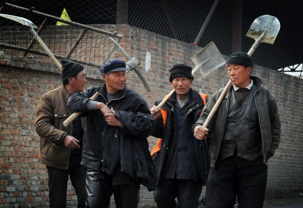 Chinese migrant workers leave their factory construction site for a lunch break in Beijing on March 16, 2012. (Mark Ralston/AFP/Getty Images) 