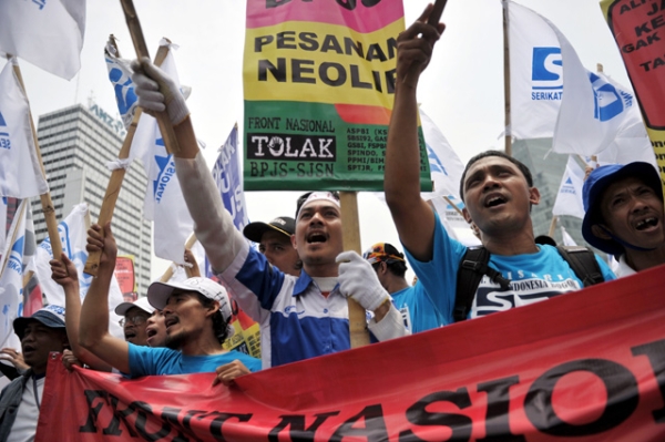 Indonesian workers display placards during a rally in Jakarta on Nov. 21, 2012, when thousands of workers took to the streets calling on the government to increase wages and end the practice of outsourcing manpower. (Bay Ismoyo/AFP/Getty Images)