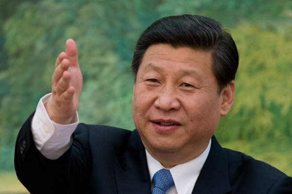 China's newly appointed leader Xi Jinping gestures as he attends a meeting with "foreign experts" at the Great Hall of the People in Beijing on December 5, 2012. (Ed Jones/AFP/Getty Images)