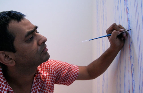 Imran Qureshi working on his site-specific painting at Asia Society Museum in 2009. (Asia Society/Bill Swersey)
