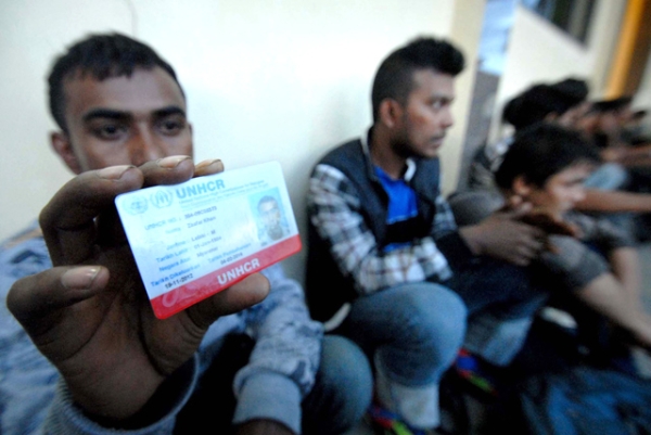 Zaafar Khan from Myanmar shows his UN High Commissioner for Refugees-issued ID on February 19, 2013, after being arrested on suspicion of trying to sail to Australia. (STR/AFP/Getty Images)