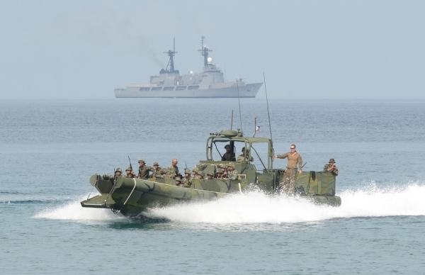Philippine and U.S. marines ride on a boat as they prepare to land on a beach facing the South China Sea during a beach assault exercises in San Antonio town, Zambales province on May 9, 2014. Scores of U.S. and Filipino marines launched mock assaults on a South China Sea beach in the Philippines on May 9 in war games aimed at honing the allies' combat skills. (Ted Aljibe/AFP/Getty Images)