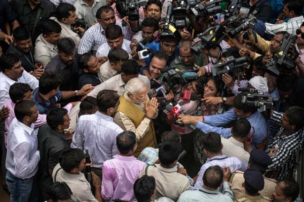 BJP leader Narendra Modi surrounded by supporters, security, and media after visiting his mother on May 16, 2014 in Ahmedabad, India. (Kevin Frayer/Getty Images)