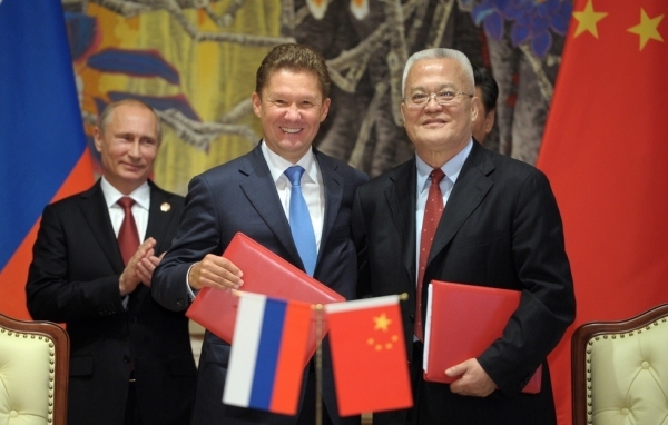 Russia's President Vladimir Putin (L) applauds during the agreement signing ceremony in Shanghai on May 21, 2014, with Gazprom CEO Alexei Miller (C) and Chinese state energy giant CNPC Chairman Zhou Jiping (R) attending the ceremony. (Alexey Druzhinin/AFP/Getty Images)