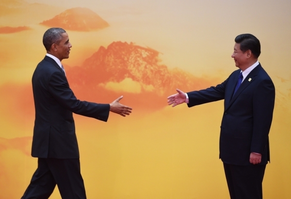U.S. President Barack Obama is greeted by Chinese President Xi Jinping as he arrives for the Asia-Pacific Economic Cooperation (APEC) leaders meeting at Yanqi Lake, north of Beijing on November 11, 2014. (Greg Baker/AFP/Getty Images)