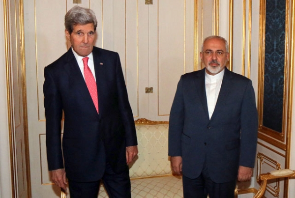 Close, but not quite there: U.S. Secretary of State John Kerry (L) and Iranian Foreign Minister Mohammad Javad Zarif prior to closed-door nuclear talks at the Palais Coburg in Vienna on Nov. 23, 2014. Asia Society's Tom Nagorski predicts a nuclear deal will be signed in 2015. (Ronald Zak/AFP/Getty Images)