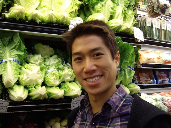 Author Tao Lin poses in front of the produce section at New York City grocery store. (Tao Lin)