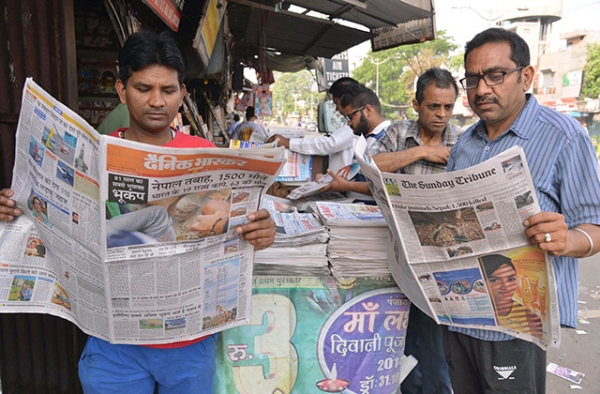 Two men in Amritsar, India read newspapers on April 26, 2015. (Narinder Nanu/AFP/Getty Images)