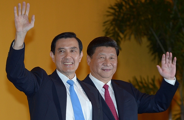 Chinese President Xi Jinping (R) and Taiwan President Ma Ying-jeou wave to journalists prior to a meeting at Shangrila hotel in Singapore on November 7, 2015. It was the first time in nearly seven decades that the top leaders of China and Taiwan met. (Mohd Rasfan/AFP/Getty Images)