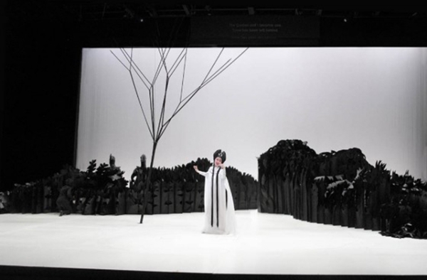 Soprano opera singer Qian Yi in front of the unique and intricate set of 'Paradise Interrupted' which is partially made of paper. (Lincoln Center Festival/Lihe Xiao)