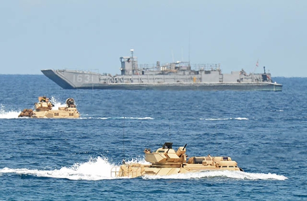 U.S. Marines amphibious assault vehicles speed past a landing ship during an amphibious landing exercise on April 21, 2015 as part of annual Philippine-U.S. joint maneuvers some 137 miles east of the Scarborough Shoal in the South China Sea — an area contested by China and the Philippines. (Ted Aljibe/AFP/Getty Images)