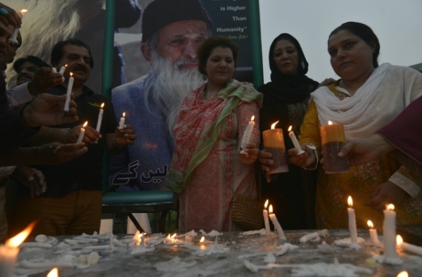 Pakistani supporters of Abdul Sattar Edhi hold candles during a candlelight vigil in his memory in Lahore on July 10, 2016. (Arif Ali/AFP/Getty Images)