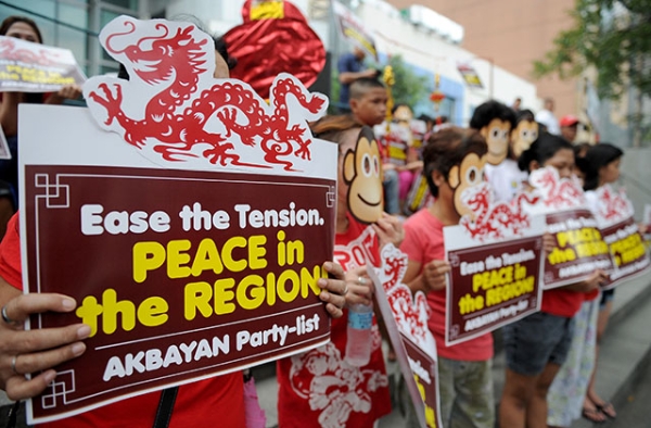 Activists wearing monkey masks display placards during a rally against Beijing's island-building in the South China Sea, ahead of the year of the monkey at the Chinese consulate in Manila on February 5, 2016. (Jay Directo/AFP/Getty Images)