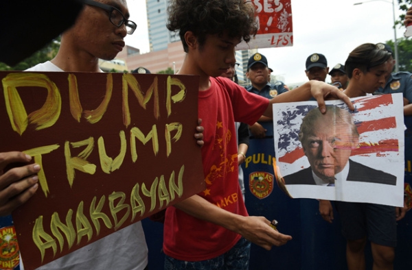 Filipino students burn an mock US flag and photo of US President-elect Donald Trump during a rally in front of the US embassy in Manila on November 10, 2016. (Ted Aljibe/AFP/Getty Images)