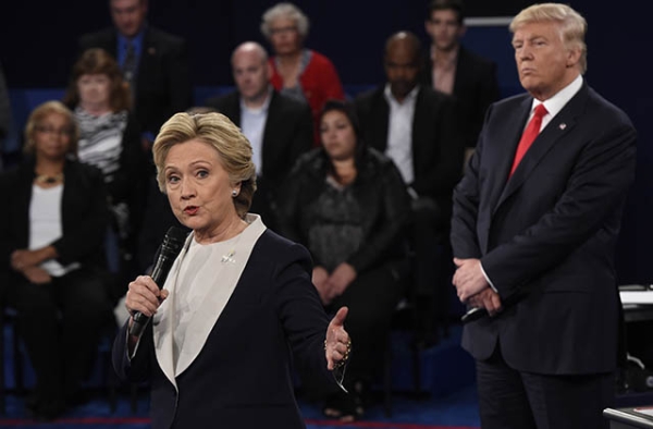 Republican nominee Donald Trump (R) watches Democratic nominee Hillary Clinton during the second presidential debate on October 9, 2016.(Saul Loeb/AFP/Getty)