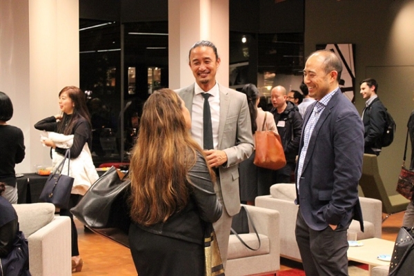 Brian Reyes, Chair of the Young Professionals Group and Asahi Choi, Financial Chair for YPG, chat with an attendee. (Asia Society)