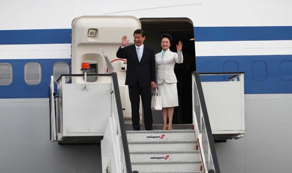 Chinese President Xi Jinping (L) and his wife Peng Liyuan (R) arrive at Julius Nyerere International Airport in Dar Es Salaam on March 24, 2013. (John Lukuwi/AFP/Getty Images)
