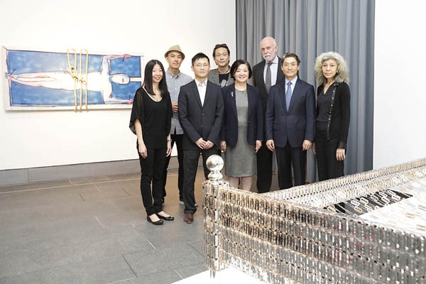 A group photo in the No Country: Contemporary Art for South and Southeast Asia” exhibition. (Left to right: June Yap, Guggenheim UBS MAP Curator of South and Southeast Asia; Tuan Andrew Nguyen, artist; Dominique Chan, Exhibition Curator of Asia Society Hong Kong Center; Vincent Leong, artist; S. Alice Mong, Executive Director of Asia Society Hong Kong Center; Richard Armstrong, Director of Solomon R. Guggenheim Museum and Foundation; Chi-Won Yoon, CEO of UBS Asia Pacific; and Araya Rasdjarmrearnsook, arti