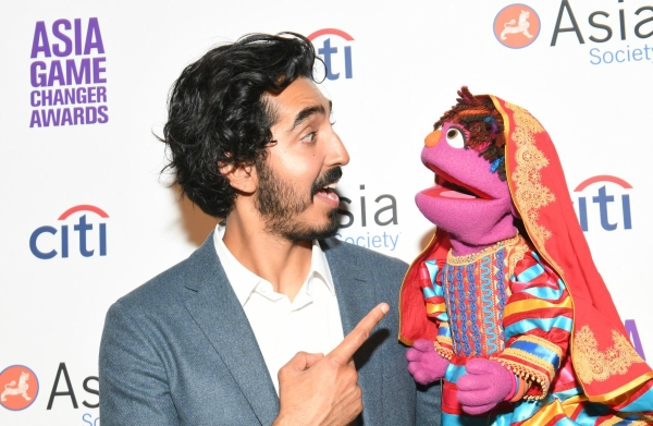 Dev Patel greets Zari the muppet at the Asia Game Changer Awards