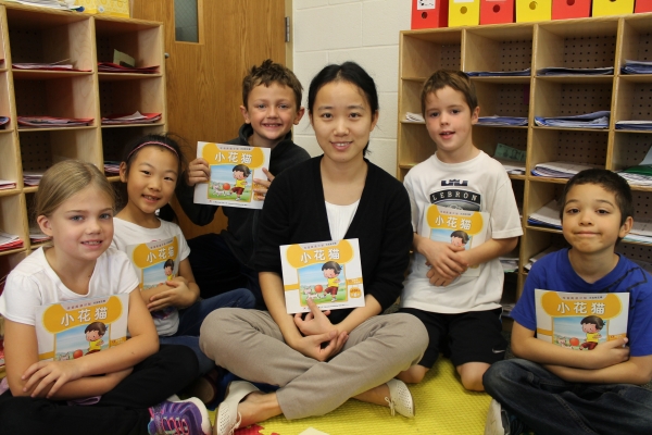 Forest Hills Public Schools elementary students read a book with their teacher.