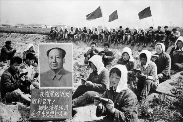 Agricultural workers in China read the Little Red Book beside a portrait of Chairman Mao Zedong during the Cultural Revolution