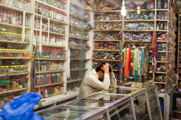At midday, a vendor rests his head in his lace shop in Lahore's Shahalami Market. (Nushmia Khan) 