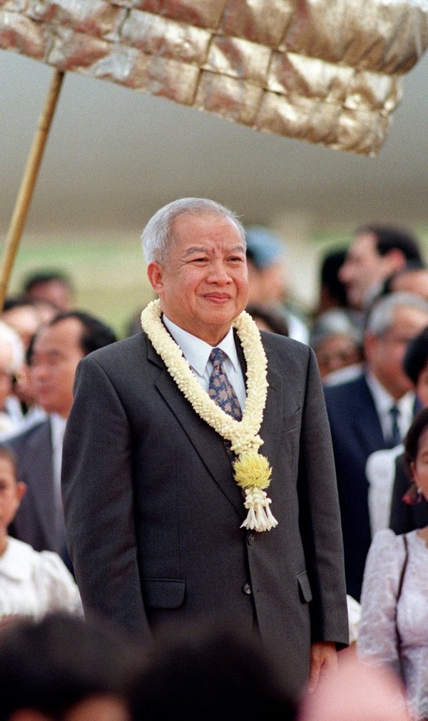 Former Cambodian king Norodom Sihanouk died of a heart attack in Beijing at the age of 89 on Oct 15, 2012. Sihanouk is shown here listening to the national anthem upon his return to Phnom Penh from a medical check-up in Beijing in 1993, when Cambodia was taking tentative steps toward democracy under a new constitution. (Doug Niven/AFP/Getty Images)
