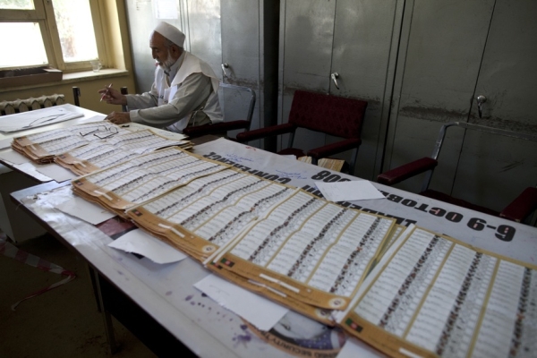 An electoral worker counts votes in a Kabul school on August 21, one day after the election. (Paula Bronstein/Getty Images)
