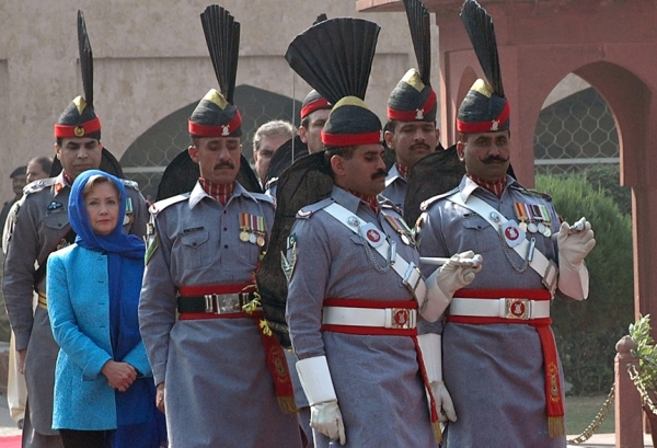 PAKISTAN, OCTOBER 29 - US Secretary of State Hillary Clinton (2nd L in blue) is escorted by Pakistan Rangers as she arrives at the tomb of Pakistan&apos;s national poet Allama Mohammad Iqbal during her visit to Lahore. Clinton&apos;s visit to the second largest city in Pakistan, which was hit by a series of gun, suicide, and grenade attacks this year, was accompanied by tight security measures a day after a car bomb killed 105 in Peshawar. (STR/AFP/Getty Images)