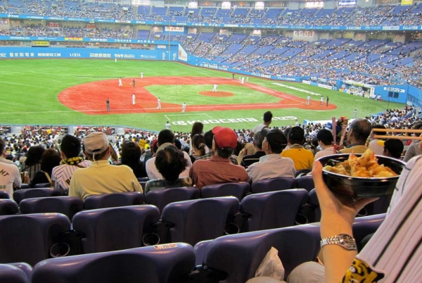 A fan enjoys his tempura in the Osaka baseball stadium. (wallyg/Flickr)