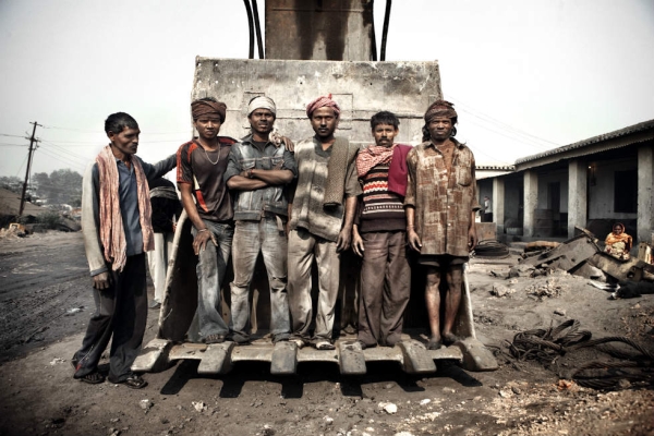 Miners pose for a photo in a mine near Dhanbad. (Erik Messori)