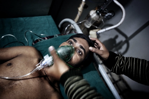 A miner with serious respiratory problems is treated with oxygen. (Erik Messori)